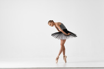ballet dancer posing on black background