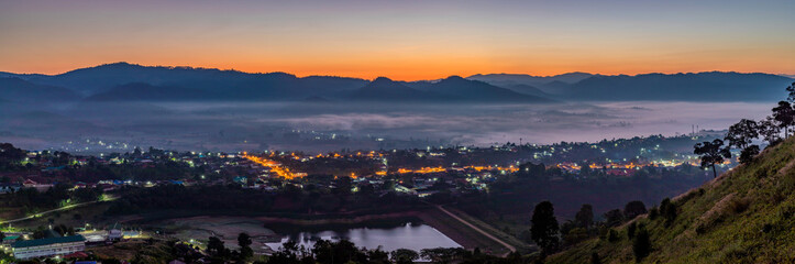 Night beautiful scene of winter landscape of shining village surrounded by mountains