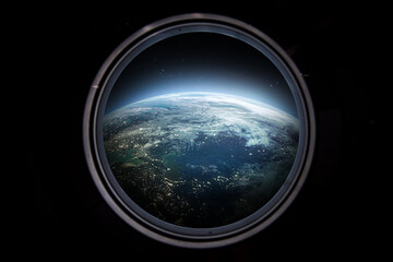 Porthole of space station. Earth on the background. Elements of this image furnished by NASA	