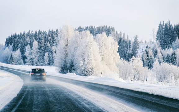 Car on Winter road with snow in Finland. Auto and Cold landscape of Lapland. Automobile on Europe forest. Finnish City highway ride. Roadway and route snowy street trip. Driving