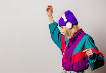 Style woman in 90s punk clothes with headphones on white color background