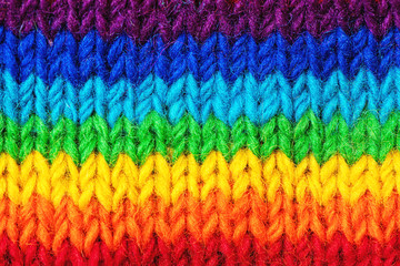 Fototapeta na wymiar Background with bright sweater pattern in rainbow colors.