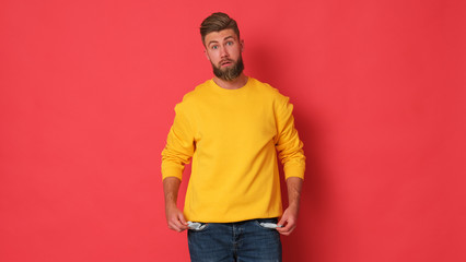 Young man is showing his pocket out. Empty pockets. 