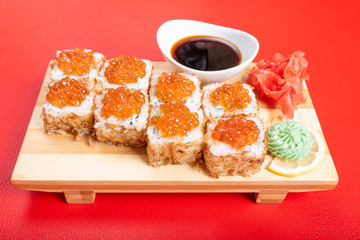 Roll in dried tuna shavings with red caviar.