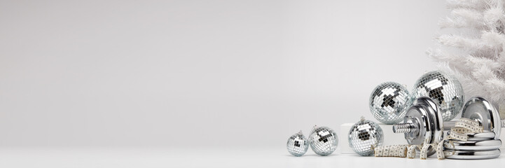 Dumbbell and Christmas ornaments. Fitness New Year and Christmas extra wide screen banner background