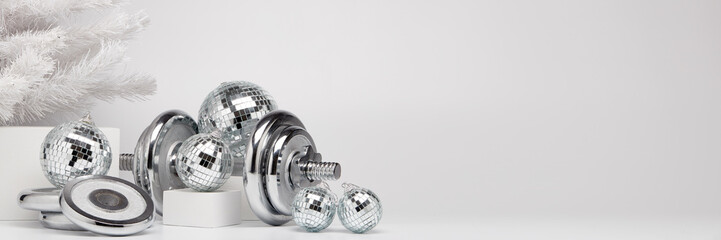 Dumbbell and Christmas ornaments. Fitness New Year and Christmas extra wide screen banner background