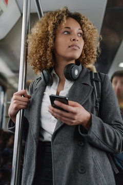Woman with smartphone on a subway