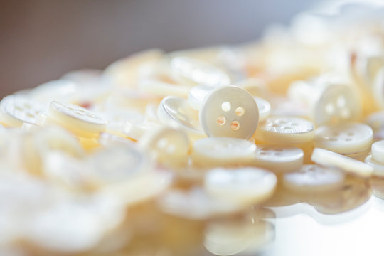 Close-up of buttons made with shells on table in workshop
