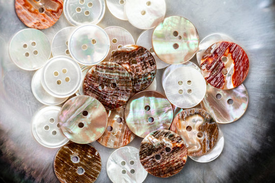 Close-up of buttons made with shells on table in workshop