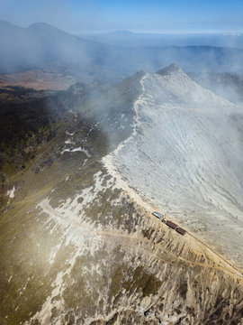 Indonesia, Java, Aerial view of smoke floating over mountains surrounding Ijen volcano