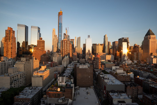 Fototapeta Sunset panorama of Manhattan's Hell's Kitchen skyline as seen from the 10th Avenue, Midtown Manhattan, New York City. Taken on September the 25th, 2019.