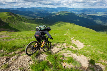 A man is riding enduro bicycle.