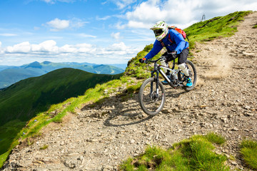 Enduro Cyclist is riding down the hill.