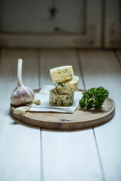 Close-up of garlic butter with ingredients on wooden table at studio