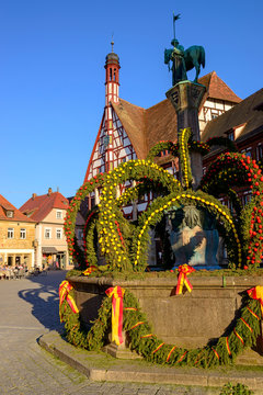 Osterbrunnen in front of town hall against clear blue sky, Forchheim, Germany