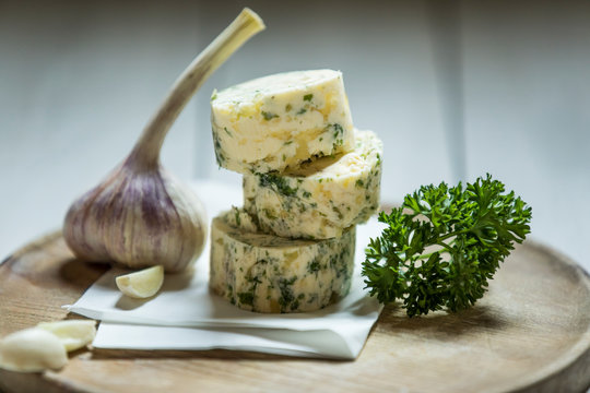 Close-up of homemade garlic butter on wooden table at studio