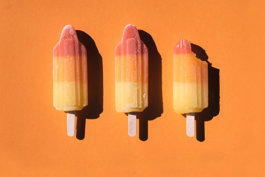Directly above shot of sorbets arranged on orange background