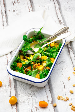 High angle view of vegetable salad served in bowl with cutleries on table