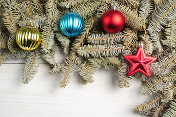 Christmas white wooden pattern with Christmas tree branches and toys