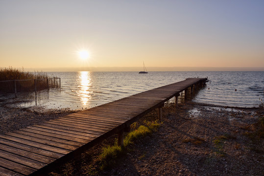 Wooden jetty at lake Ammersee in Upper Bavaria during sunset