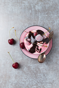 Directly above shot of cherry ice cream with chocolate sauce served in bowl on table
