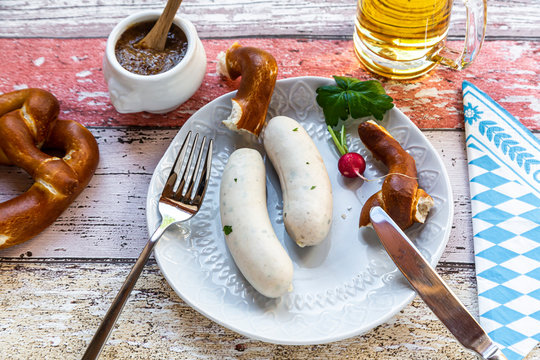 White sausage breakfast with pretzels, mustard and beer