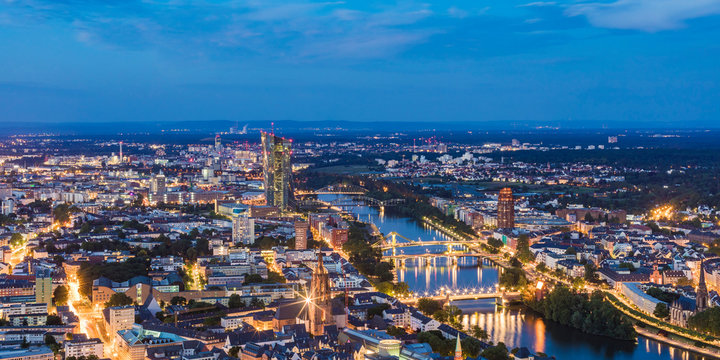 Illuminated cityscape against blue sky at night, Frankfurt, Hesse, Germany