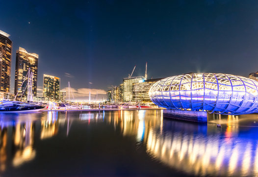 Illuminated Webb Bridge over Yarra river in Docklands against sky at night, Melbourne, Australia
