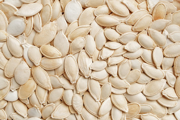 Unpeeled pumpkin seeds texture. Top view, flat lay