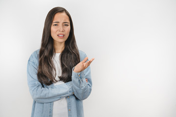 Young asian woman unhappy for not understand something over white isolated background