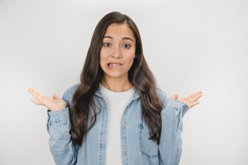 Portrait of asian indecisive woman shrugging and throwing hands aside isolated over white background