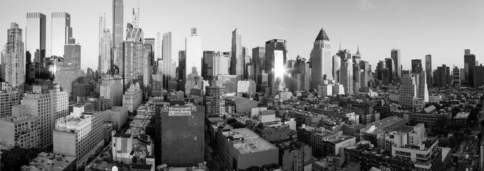 Black and white sunset panorama of Manhattan's Hell's Kitchen skyline as seen from the 10th Avenue,...