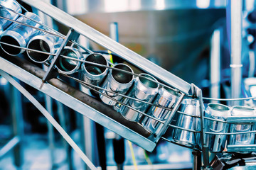 Conveyor belt with tin beer cans. Automated production of beer beverage, beverage bottling in cans.