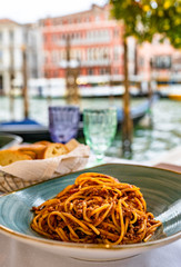 Pasta spaghetti bolognese in Venice, Italy at outside terrace restaurant on the grand canal. Tradidional italian food.