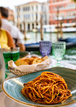 Pasta spaghetti bolognese in Venice, Italy at outside terrace restaurant on the grand canal. Tradidional italian food.