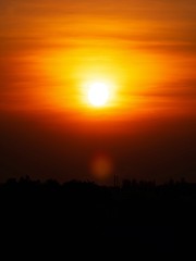 Beautiful sunset over sea. Tranquil scene of Closeup red sun and red sky sunset over the ocean