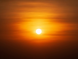 Beautiful sunset over sea. Tranquil scene of Closeup red sun and red sky sunset over the ocean