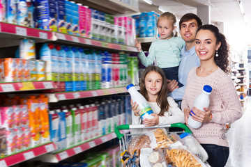 Couple with children selecting dairy products