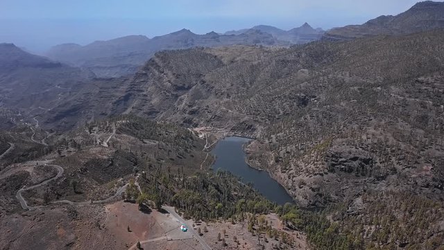 Flight over desert landscape in caldera of Tejeda and Presa del  lake, Gran Canaria, Canary islands, Spain.