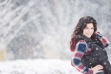 Beautiful young woman in snowfall