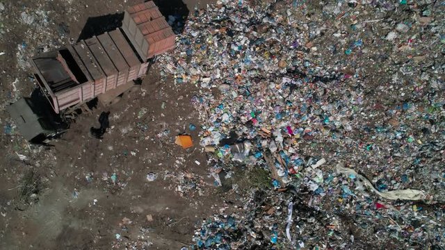 Aerial view of garbage truck at landfill, garbage disposal. Environmental pollution concept