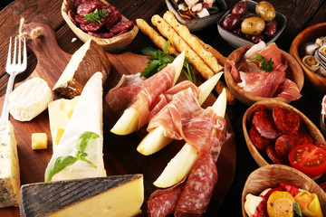 Italian antipasti wine snacks set. Cheese variety, Mediterranean olives, seafood salad, Prosciutto...