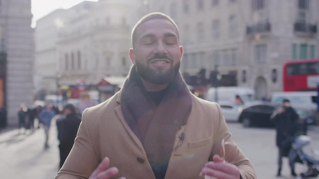 Portrait of male presenter talking to camera out in the city