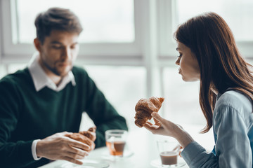 young couple having breakfast in cafe
