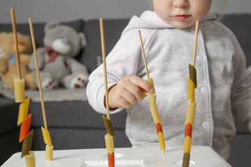 Fine motor pasta threading activity for kids. An easy and fun tower building challenge that works...