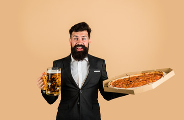 Restaurant or pizzeria. Bearded man with tasty pizza and beer in hands. Smiling man with beard holds delicious pizza in box and cold beer. Fast food. Italian food. Pizza time. Pizza delivery concept.