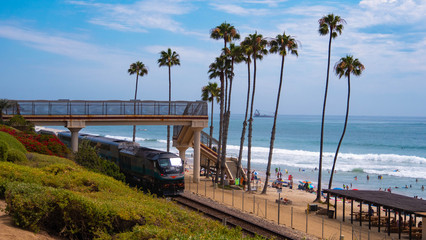 Train traveling through San Clemente at the beach - obrazy, fototapety, plakaty