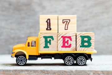 Truck hold letter block in word 17feb on wood background (Concept for date 17 month February)
