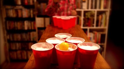 Playing beer pong at college party