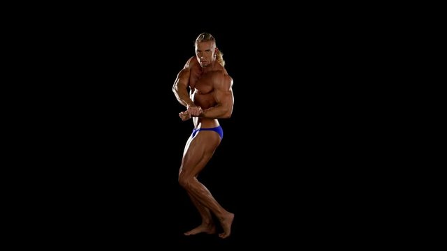 Bodybuilder posing over black background